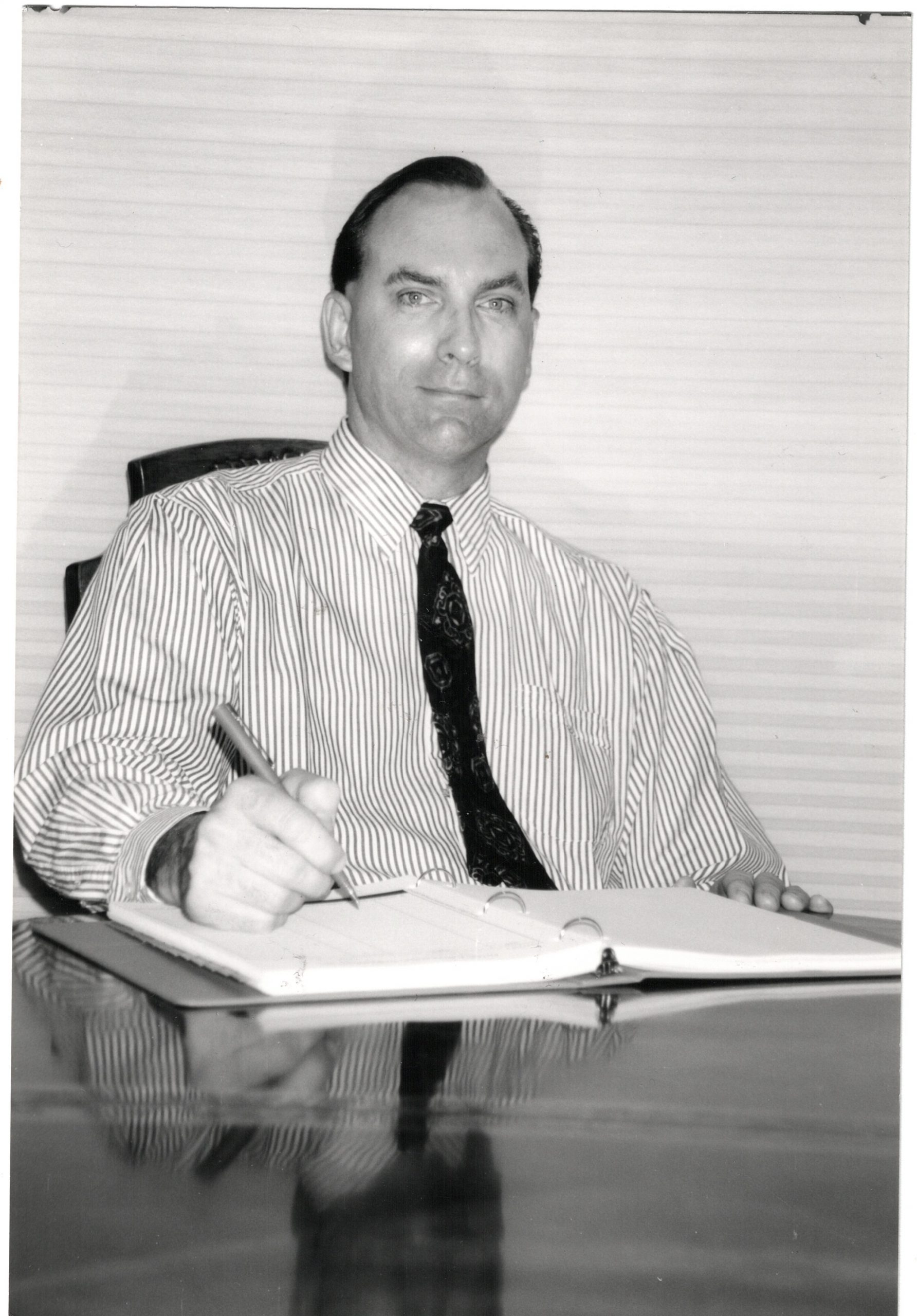 A younger Randy holding the original printed edition of The Getting Ahead Guidebook